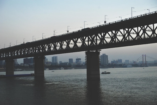 Bridge over sea against clear sky in city
