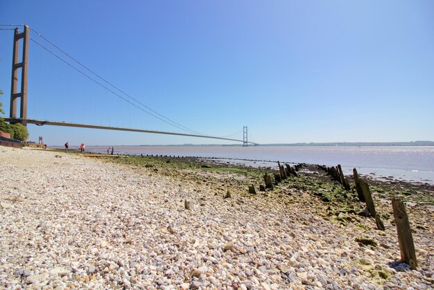 Bridge over sea against clear sky