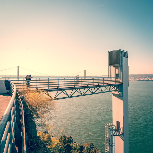 Bridge over sea against clear sky