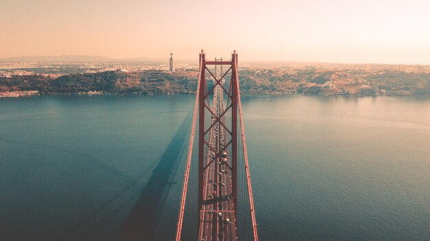 Photo bridge over sea against sky during sunset