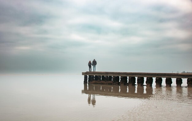 Bridge over sea against sky