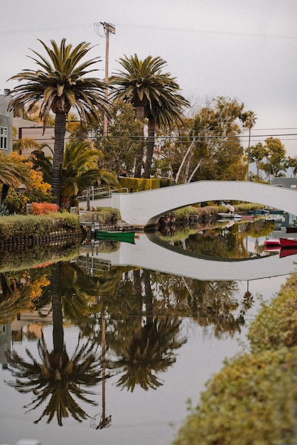 A bridge over a Venice canal with a boat in the water Venice beach