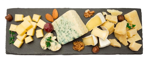 brie, camembert, roquefort and cheddar on stone board