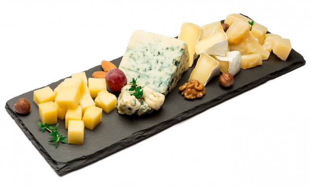 brie, camembert, roquefort and cheddar on stone board