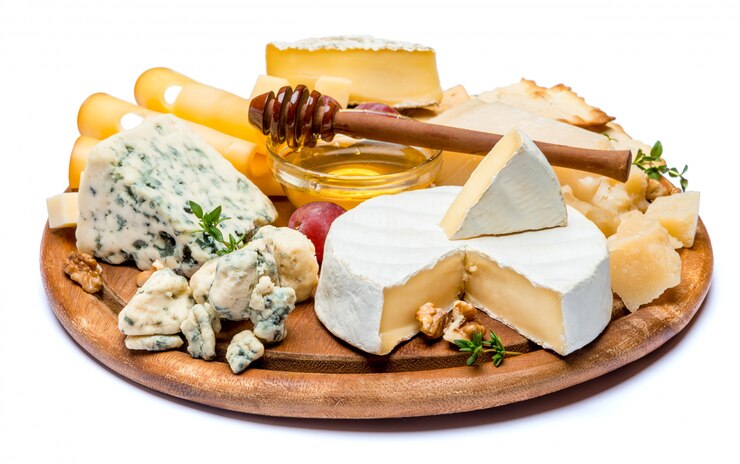 brie, camembert, roquefort and cheddar on wooden board