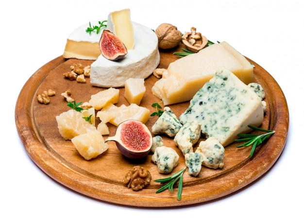 brie, camembert, roquefort and cheddar on wooden board