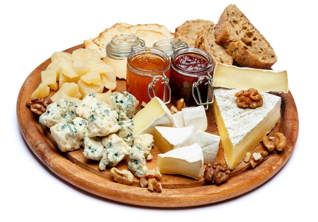 Brie cheese on a wooden Board with bread and sweet jam