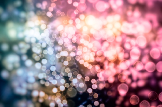 Bright abstract circular bokeh background blur on a dark background