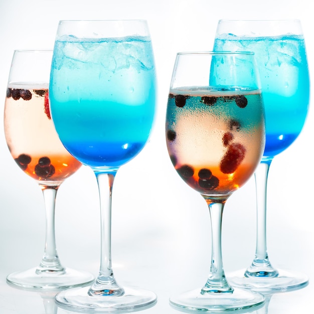 Bright alcoholic cocktails on white background