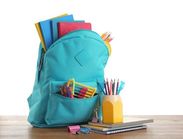 Bright backpack with school stationery on white background