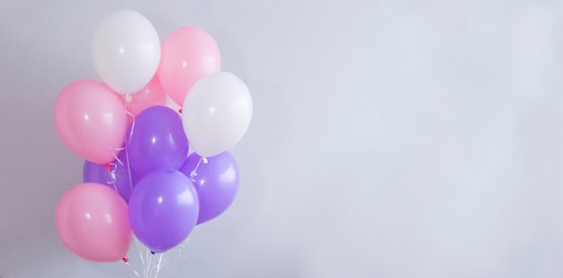 Bright balloons on a gray background