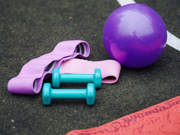 Bright bar bells, ball and rubbers for fitness