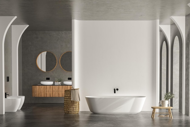 Bright bathroom interior with concrete floor and wall, white\
bathtub and two sinks, toilet and bidet