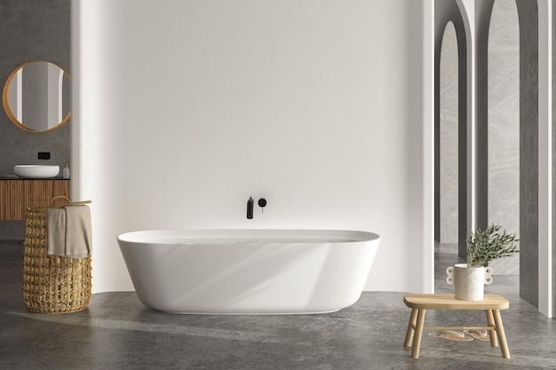 Bright bathroom interior with concrete floor and wall, white\
bathtub and two sinks, toilet and bidet