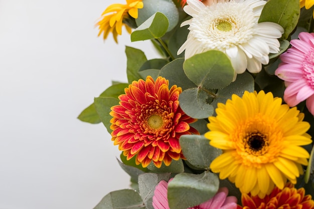 Bright beautiful bouquet with yellow orange and red flowers daisies fragment closeupfloral texture m