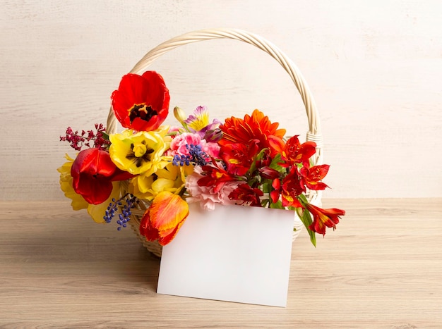 Bright beautiful flowers in a basket with a postcard with a place for your inscription