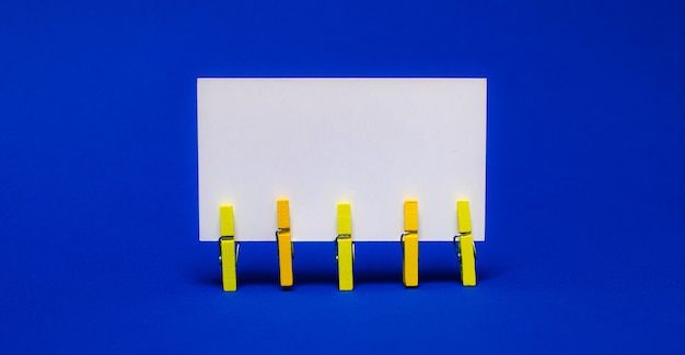 Bright blue background on yellow clothespins