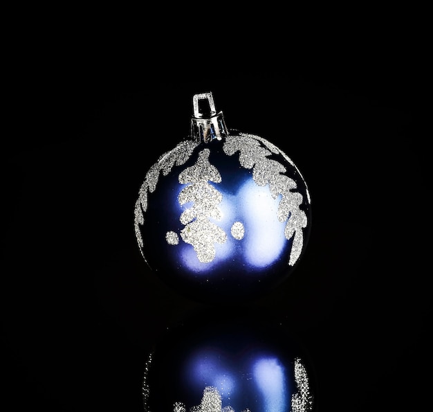 Bright blue Christmas ball on a black background