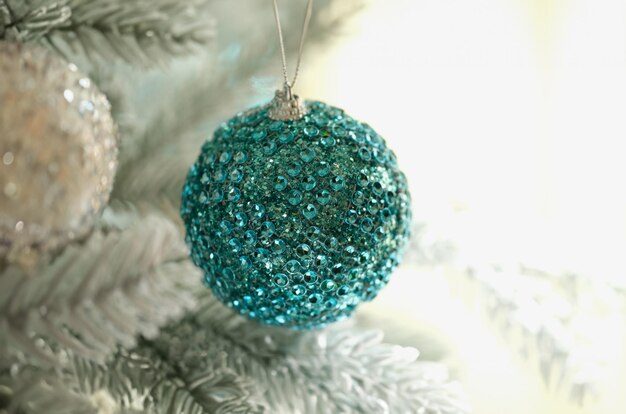 Bright blue christmas tree ball with shiny stones closeup