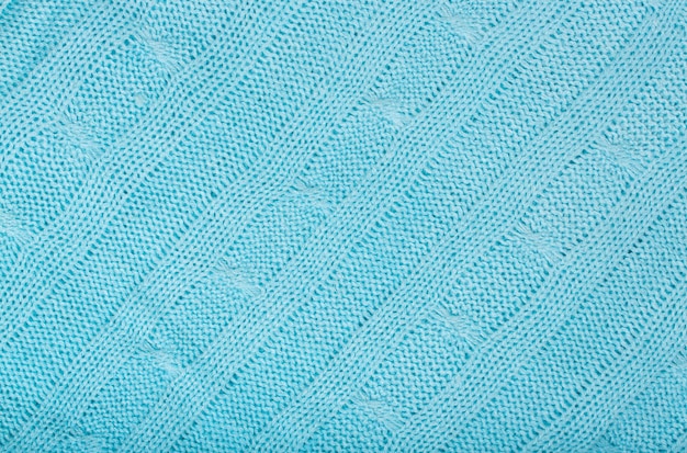 Bright blue coloured knitted surface. Background