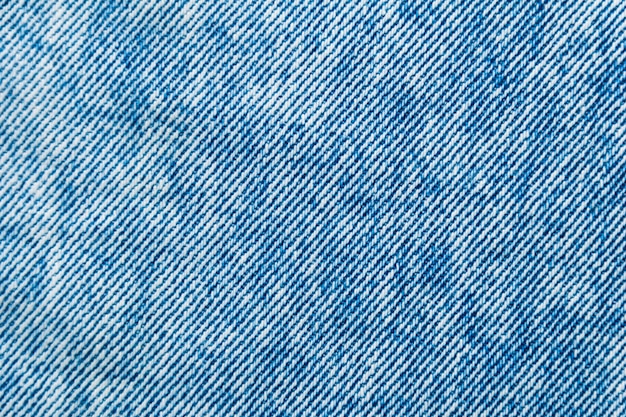 bright blue faded jeans background. denim fabric texture