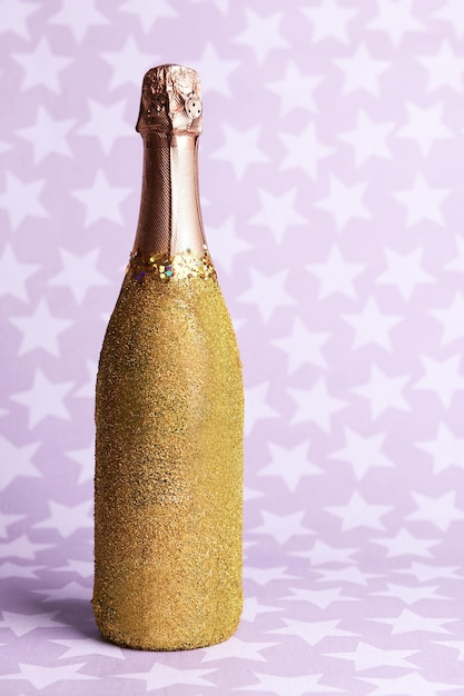 Bright bottle of champagne on paper background