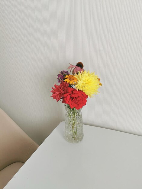 Bright bouquet of flowers on the table in a glass vase