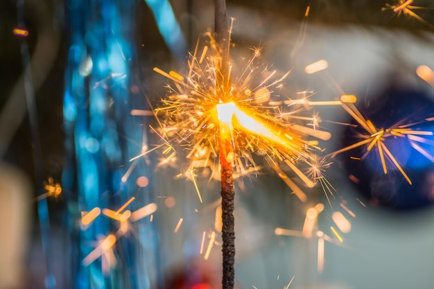 Bright burning spakler on a tree at christmas