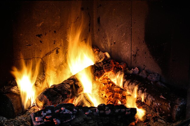 Bright burning wood in a fireplace with sparks closeup