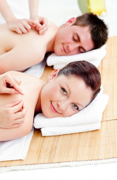 Bright caucasian couple receiving a back massage