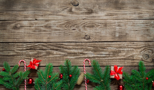 Bright Christmas arrangement of fir tree branches, sweet red canes, red Christmas balls