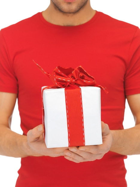 bright closeup picture of man's hands holding gift box.