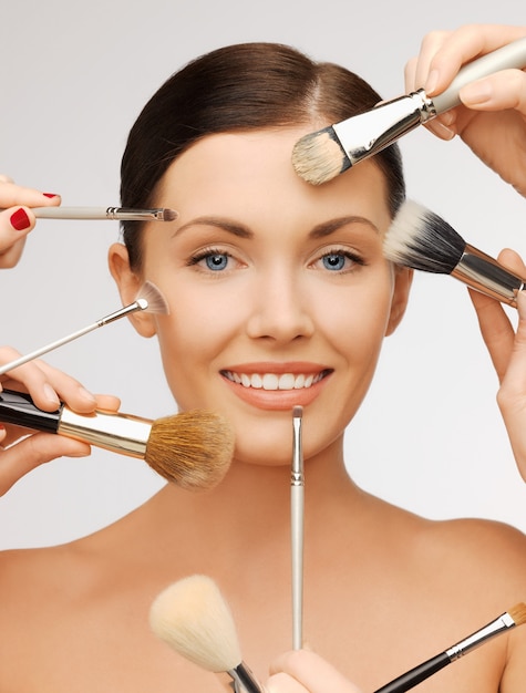 bright closeup portrait picture of beautiful woman with brushes