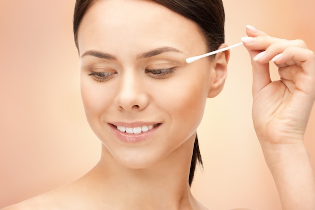 bright closeup portrait picture of beautiful woman with cotton bud