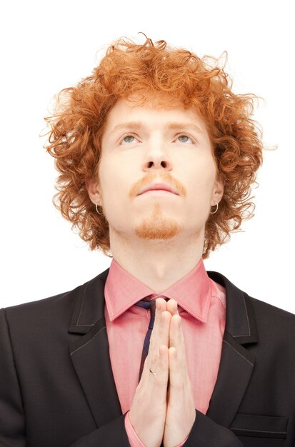 bright closeup portrait picture of praying businessman