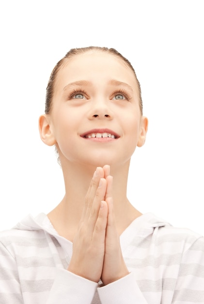 bright closeup portrait picture of praying teenage girl