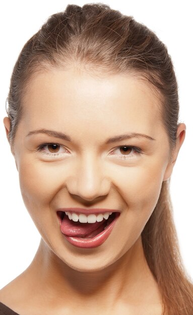 bright closeup portrait picture of teenage girl sticking out her tongue