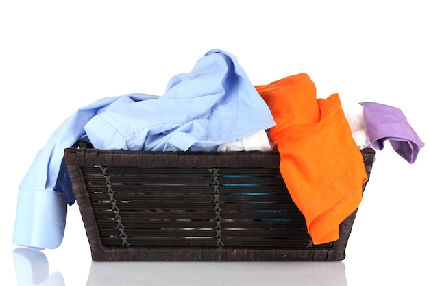 Bright clothes in laundry basket isolated on white