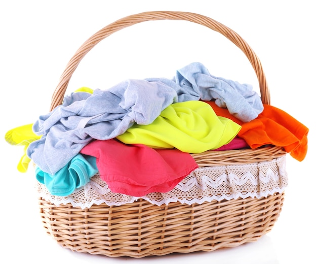 Bright clothes in laundry basket isolated on white