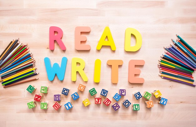 Bright color wooden WRITE and READ signs on wood desk.