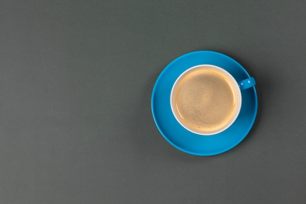 Bright colored coffee cup on table top view