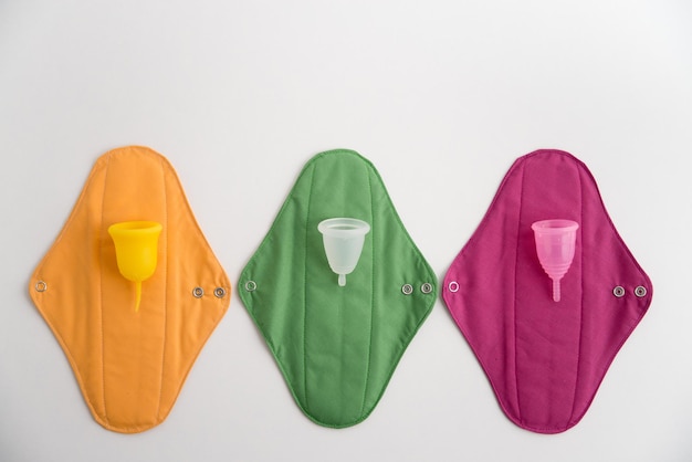 bright colored cotton pads and menstrual cups for feminine hygiene