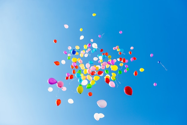 Bright colorful balloons over blue sky