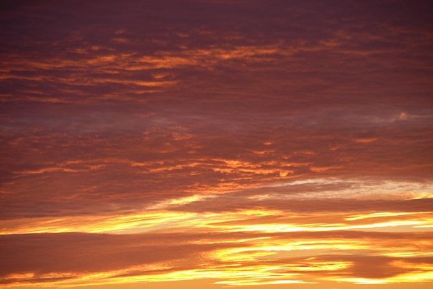 Bright colorful sunset sky with rays of setting sun and vivid dark clouds