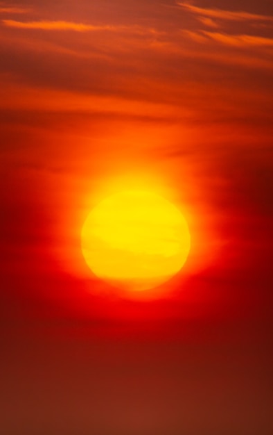 Bright crimson sun on a background of sunset or dawn