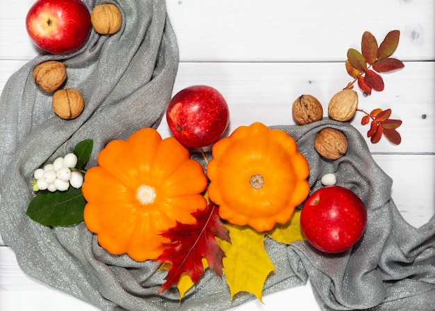 Bright fall horizontal background with orange pumpkins and red apples nutsgreen and yellow leaves