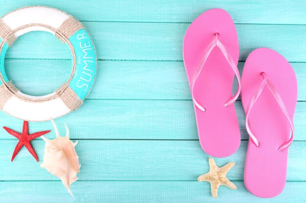 Bright flipflops on color wooden background