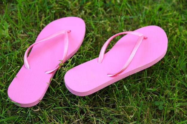 Bright flipflops on green grass