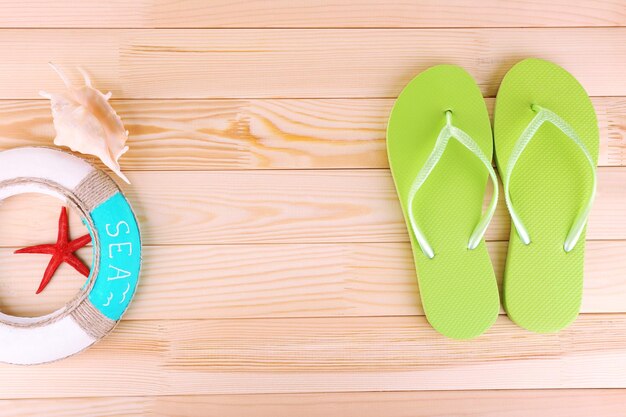 Bright flipflops on wooden background