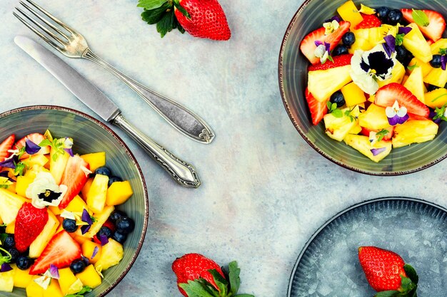 Bright fruit salad with edible flowers